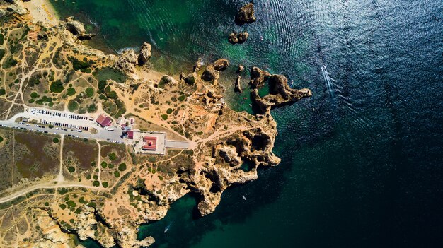 Aerial view of Ponta da Piedade of Lagos, Portugal. Beauty landscape of rugged seaside cliffs and aqua ocean waters in the Algarve region of Portugal