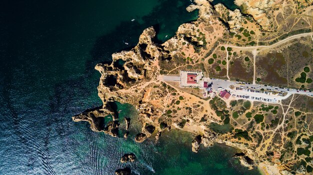 Aerial view of Ponta da Piedade of Lagos, Portugal. Beauty landscape of rugged seaside cliffs and aqua ocean waters in the Algarve region of Portugal