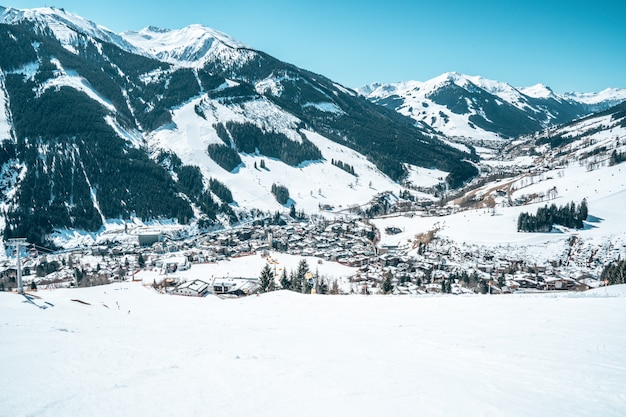 Aerial view of a resort town in Austria surrounded by snowy mountains