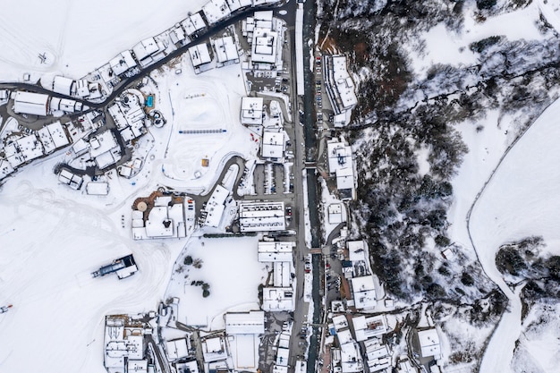 Aerial view of a resort town in Austria surrounded by snowy mountains