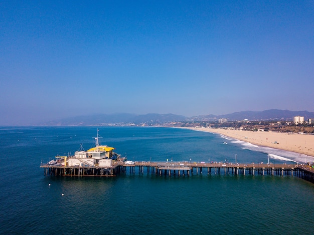 aerial view of the santa monica amusement park with roller coaster in los angeles, california