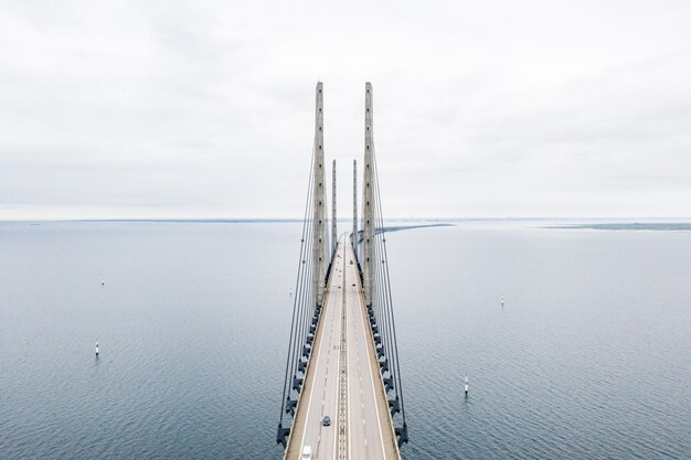 Aerial view of a self-anchored suspension bridge on a blue sea