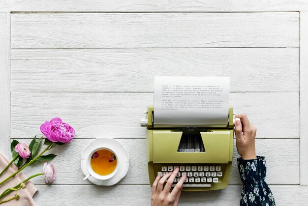 Aerial view a woman using a retro typewriter