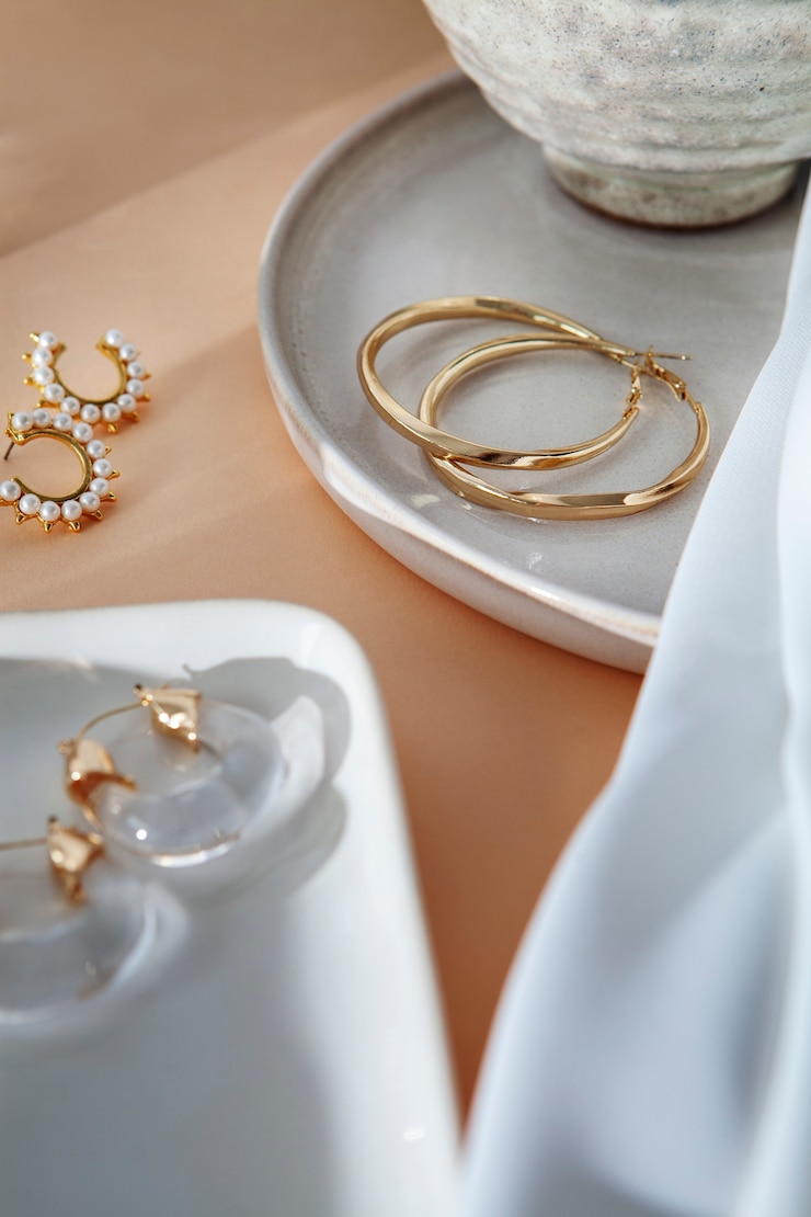 Free Photo aesthetic golden earrings arrangement