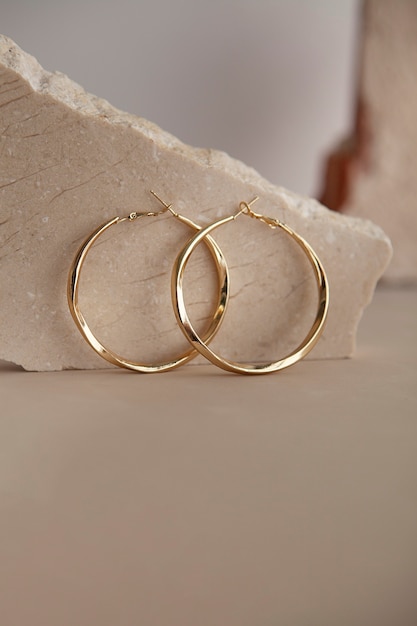 Free photo aesthetic golden earrings arrangement