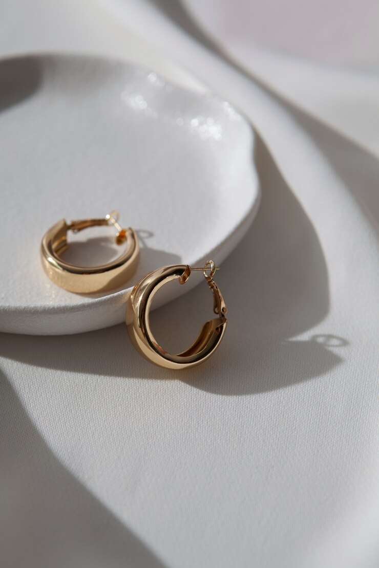 Free Photo aesthetic golden earrings high angle