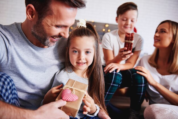 Affectionate father giving christmas present to his daughter