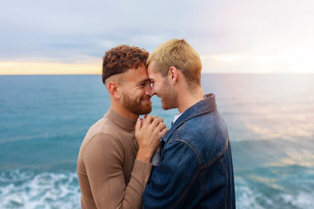 Affectionate gay couple spending time on the beach together