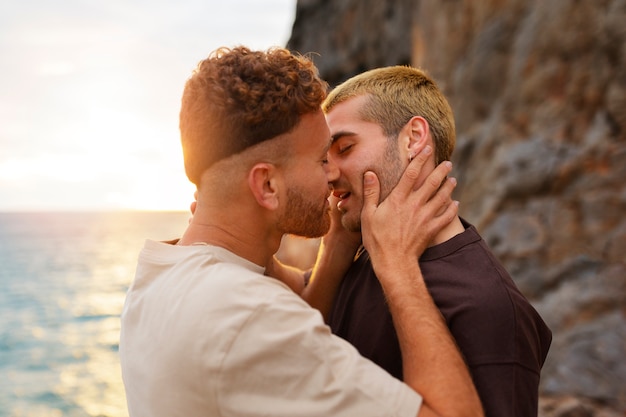 Free photo affectionate gay couple spending time together on the beach