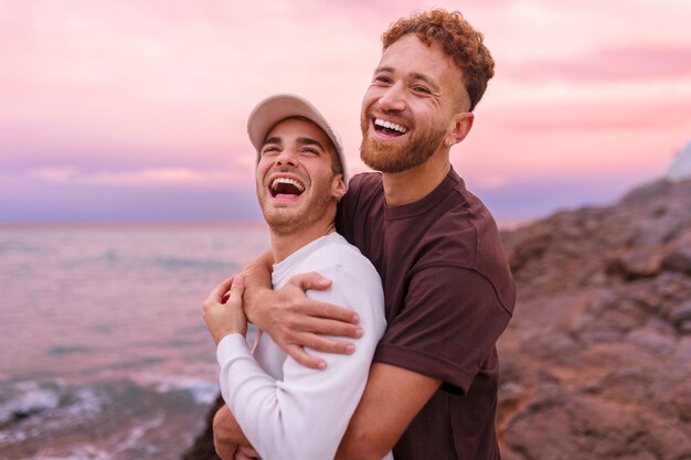 Affectionate gay couple spending time together on the beach