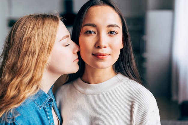 Affectionate lesbian couple at home