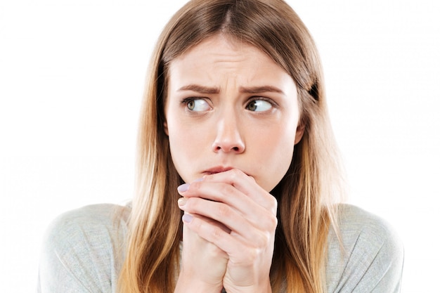 Free photo afraid woman holding fists