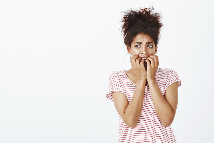 Free Photo afraid woman with afro hairstyle posing in the studio