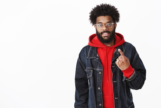 african american adult guy stopping buy on way work showing index finger as counting and smiling, making order smiling friendly.