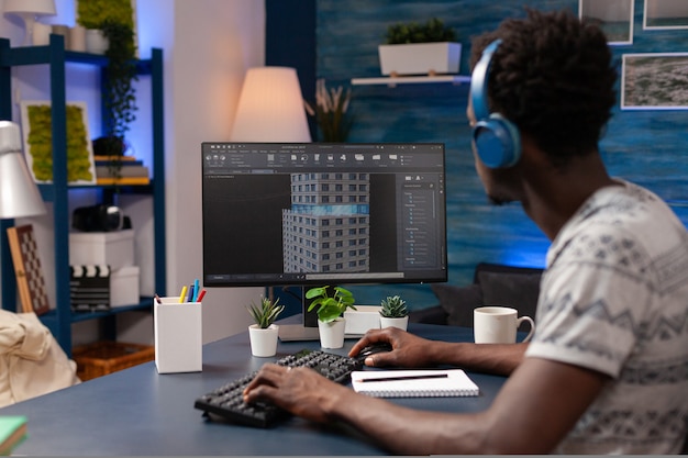 African american architect man analyzing corporate building plan on computer