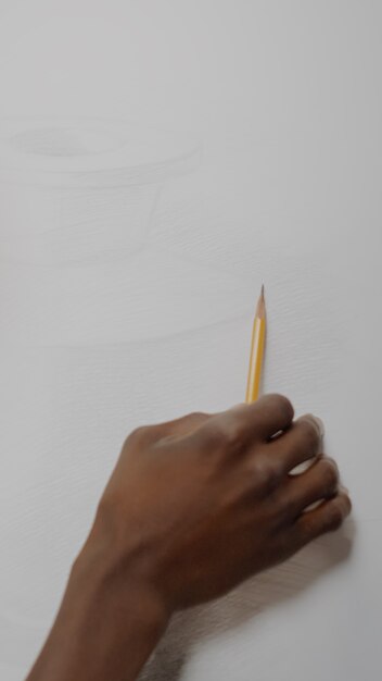 African american artist creating drawing of vase with pencil