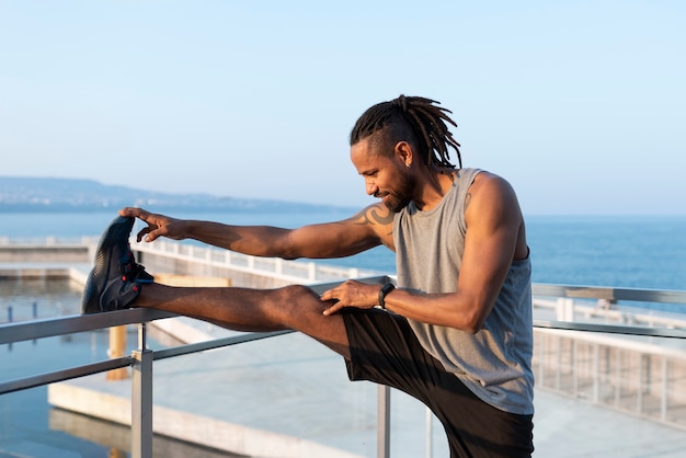 African american athlete stretching outdoors