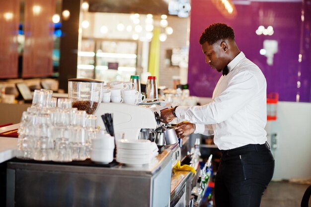 African american bartender barista at bar preparing coffee