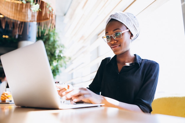 Donna di affari dell'afroamericano con il computer portatile