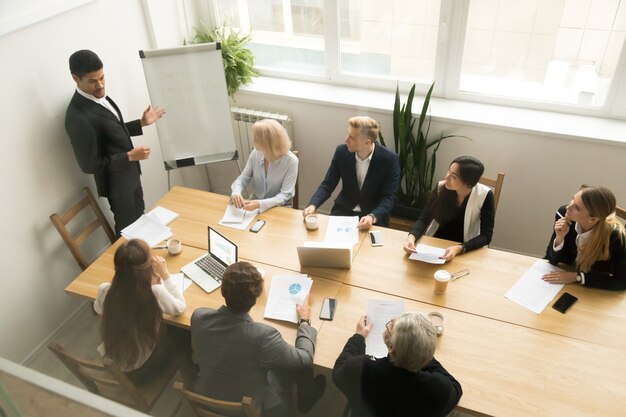 african american ceo giving presentation at corporate team meeting concept