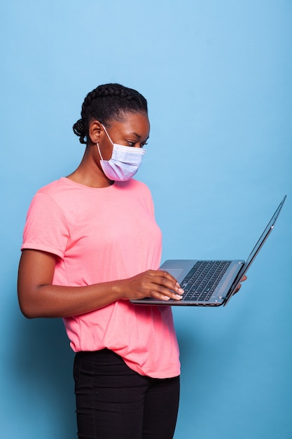 African american copywriter teenager with medical face mask against coronavirus