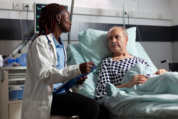 African american doctor reading diagnosis from clipboard