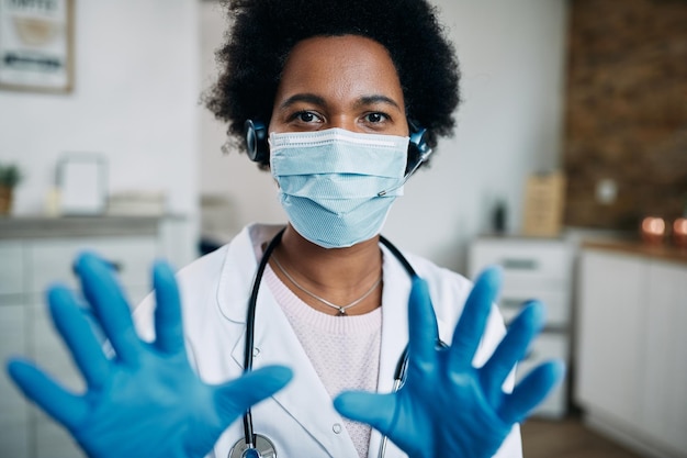 African American female doctor talking during conference call due to COVID19 pandemic