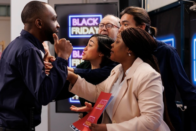 Free photo african american guy security guard talking with angry rude diverse people customers waiting for black friday shopping, police officer patrolling retail store entrance during seasonal sales