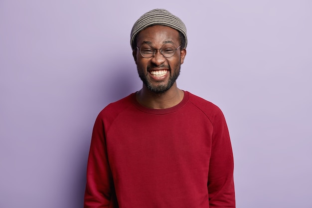 African American guy wearing red shirt and trendy hat