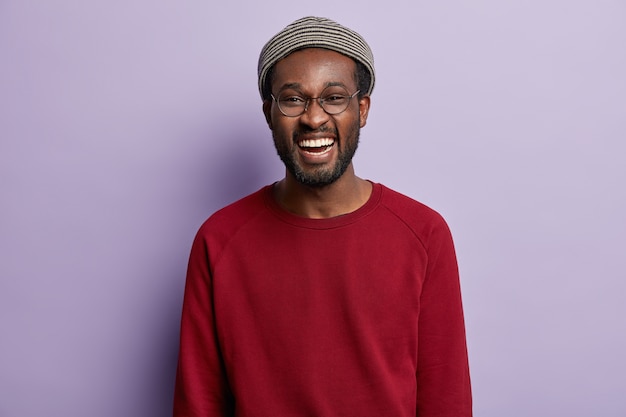 African American guy wearing red shirt and trendy hat