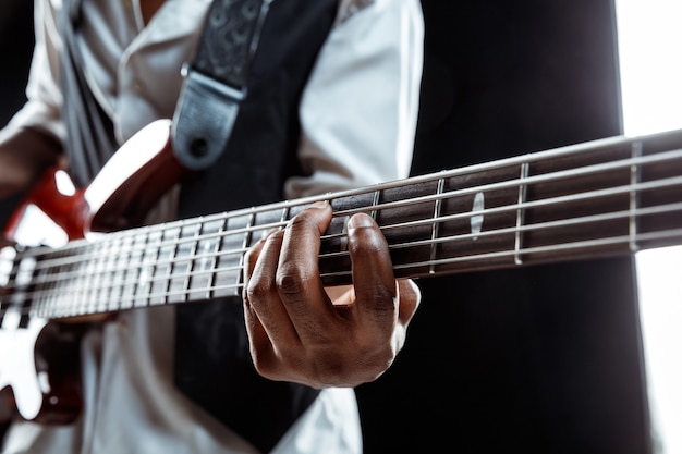 African American jazz musician playing bass guitar.