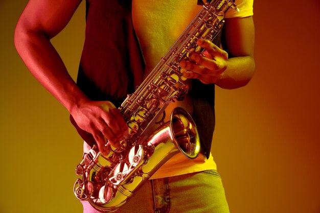 African American jazz musician playing the saxophone.