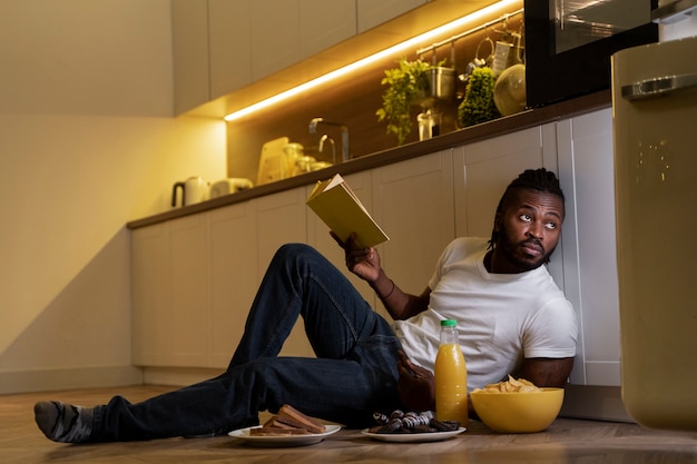 african american man eating and reading