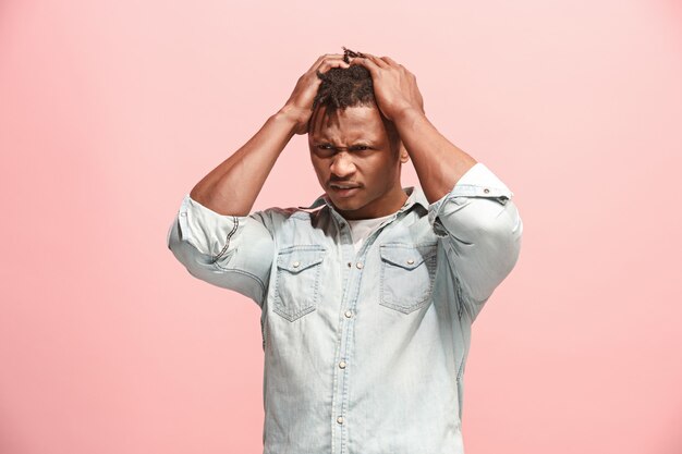 African American Man having headache. Isolated over pink.