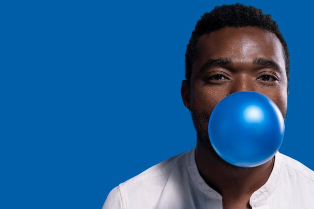 African american man holding a blue balloon