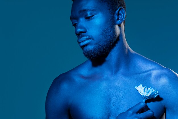 African american man holding a flower