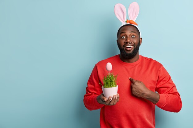 African American man holding plant