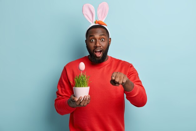 African American man holding plant