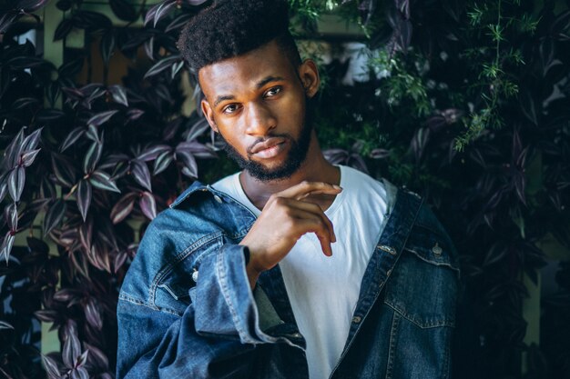 African american man model outside in park on leaves background