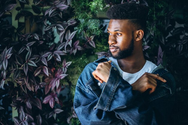 African american man model outside in park on leaves background