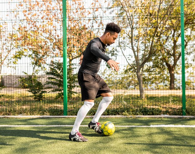 African american man playing with a soccer ball