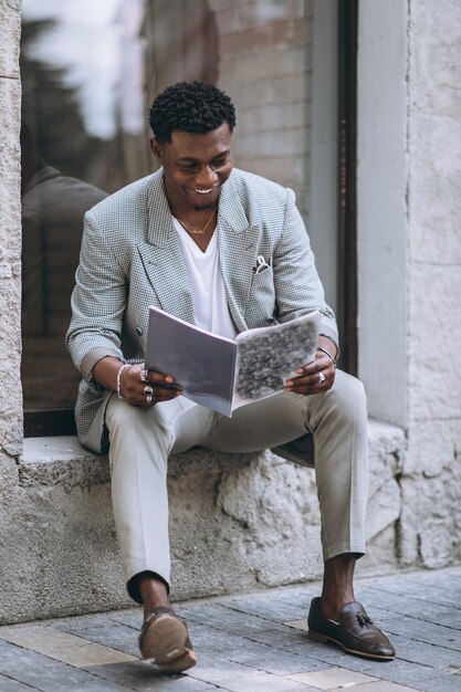 African american man reading magazine