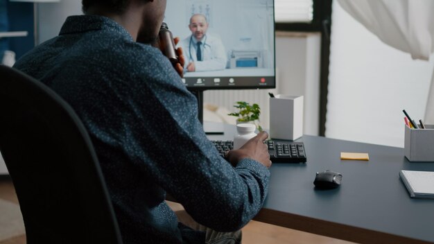 African american man seeking medical help from doctor via online intenet telehealth consultation with family medic. Health care checkup via video virtual conference, patient seeking medicine advice