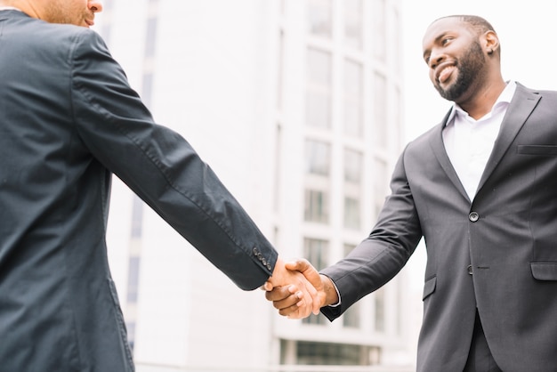 African-American man shaking hand of colleague
