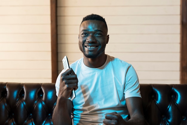 African american man watching a movie on streaming service