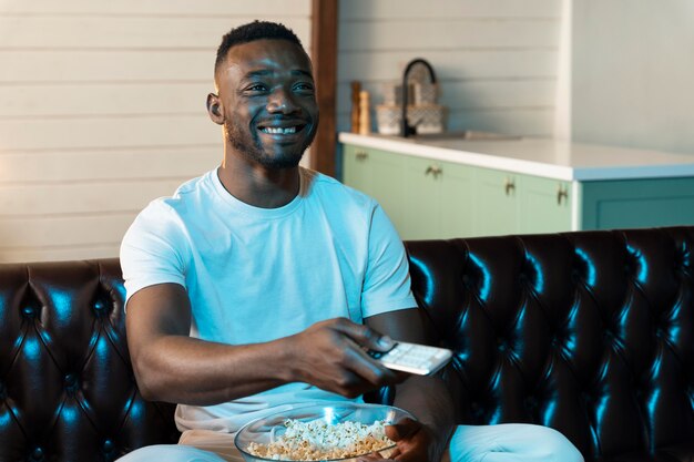 African american man watching a movie on streaming service