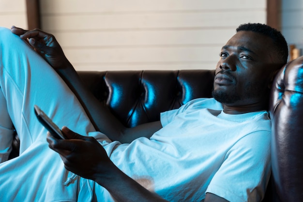 African american man watching a movie on streaming service