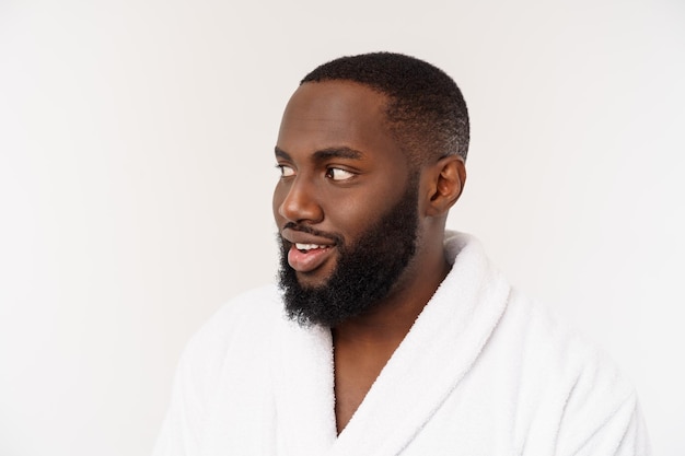 Free photo african american man wearing a bathrobe with surprise and happy emotion isolated over whtie background