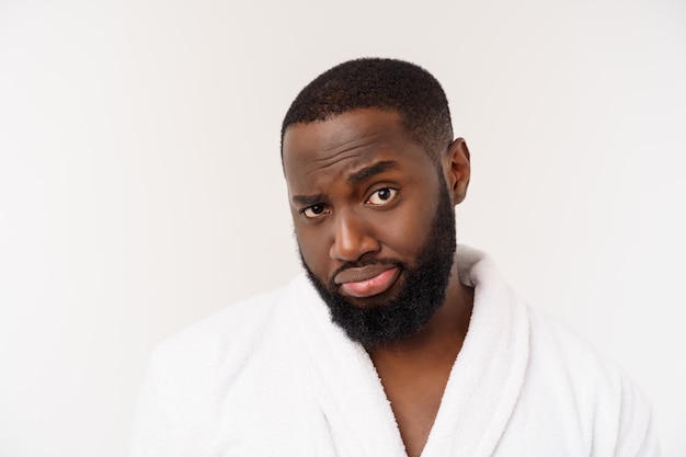 African american man wearing a bathrobe with surprise and happy emotion isolated over whtie background