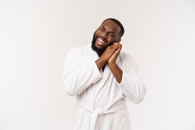 African American man wearing a bathrobe with surprise and happy emotion Isolated over whtie background